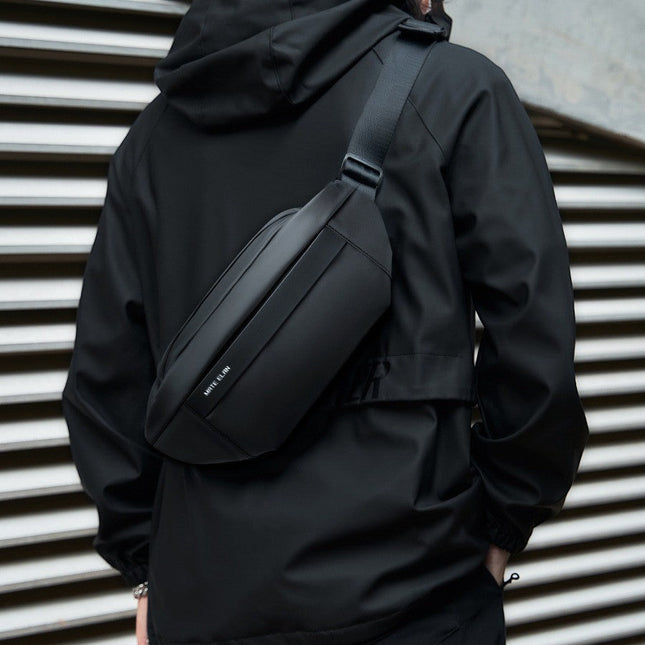 Crossbody väska i vattentåligt material, flera fack